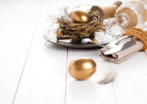 table decoration on white wooden background with Chicken golden egg