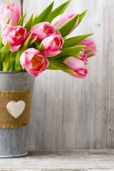 Pink tulips in a bucket. Home Decor.