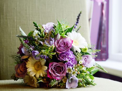 Brides bouquet with purple and white flowers on wedding day