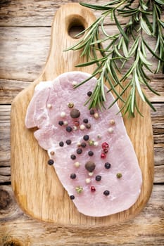 Pork chop, meat slices  on a wood background.