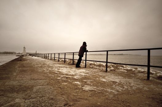 Softly textured image of person on pier.