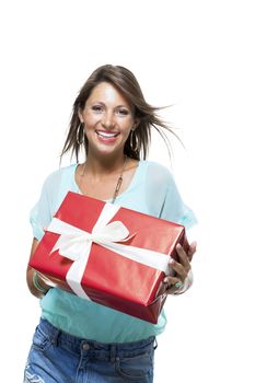 Close up Portrait of Happy Young Woman in Casual Clothing Holding a Red Big Gift Box with White Ribbon While Looking at the Camera. Isolated on White Background.