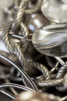 Close up of three attractive shiny purple beads attached by silver chains on an item of jewellery in a fashion and handicraft concept