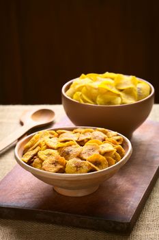 Bowls of sweet (front) and salty (back) plantain chips, a popular snack in South America photographed with natural light (Selective Focus, Focus one third into the first bowl) 