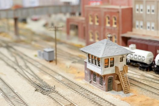 miniature model track-side signal box in a freight yard