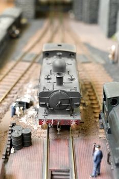 closeup of a model steam locomotive in a goods yard