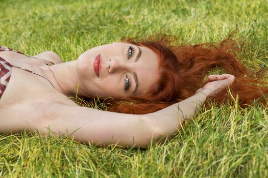 Close up Very Happy Young Woman Lying on Grassy Ground