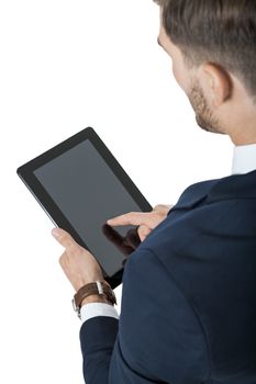 Businessman using a tablet computer navigating the touchscreen with his finger as he surfs the internet, close up view of his hands and the tablet, on white