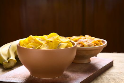 Bowls of salty (front) and sweet (back) plantain chips, a popular snack in South America photographed with natural light (Selective Focus, Focus on the upper chips) 