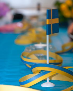 Swedish table flag on table with serpentines in blue and yellow.