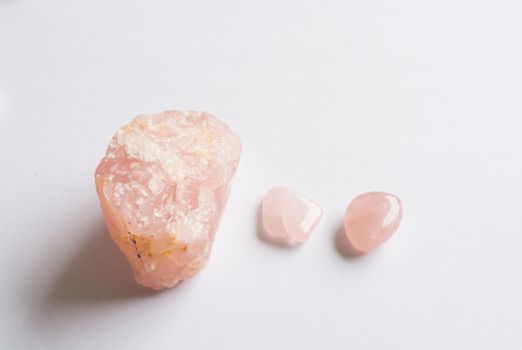 Three Rose Quartz stones on white