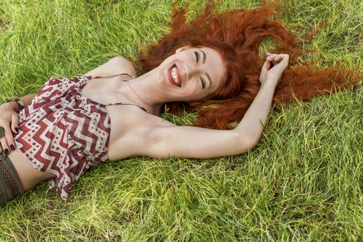Close up Very Happy Young Woman Lying on Grassy Ground