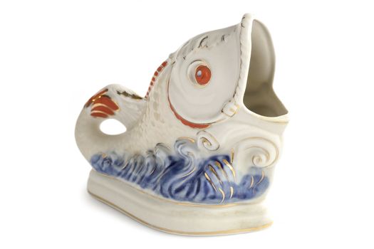 Porcelain figurine of a fish on the waves.