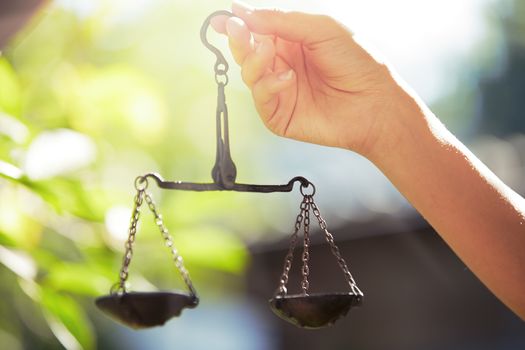 Woman hand holding scales. Horizontal photo