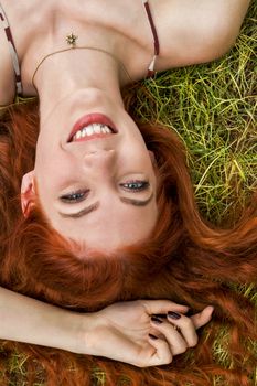 Close up Very Happy Young Woman Lying on Grassy Ground