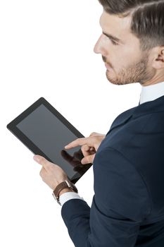 Businessman using a tablet computer navigating the touchscreen with his finger as he surfs the internet, close up view of his hands and the tablet, on white