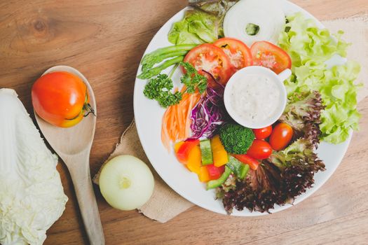 fresh vegetable salad on wood background