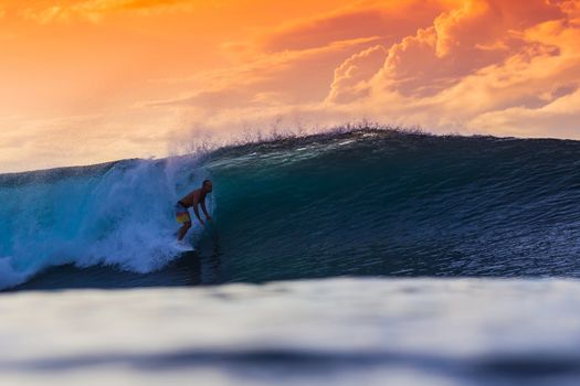 Surfer on Amazing Wave at sunset time, Bali island.