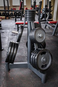 Gym interior with barbell plates holder rack