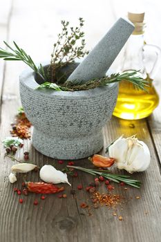 Spices and herbs in granite mortar shallow dof