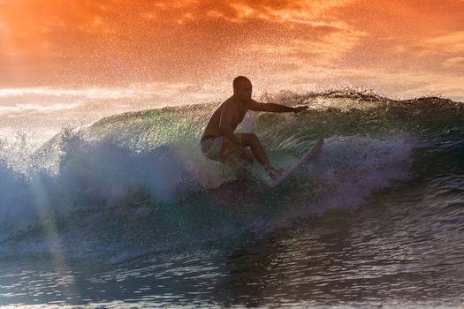 Surfer on Amazing Wave at sunset time, Bali island.