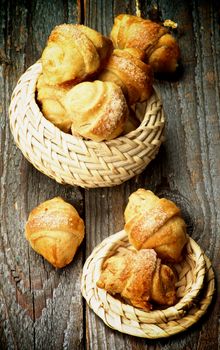 Arrangement of Croissant Cookies with Jam in Wicker Bowls closeup on Wooden background