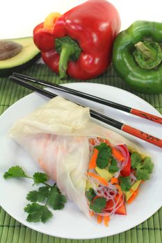 Rice paper stuffed with glass noodles, carrots, peppers and cilantro