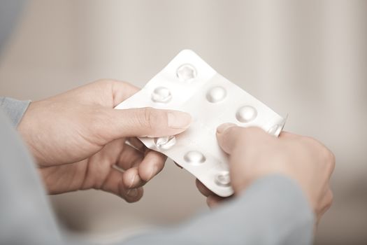 Hands of woman holding pack of medicament