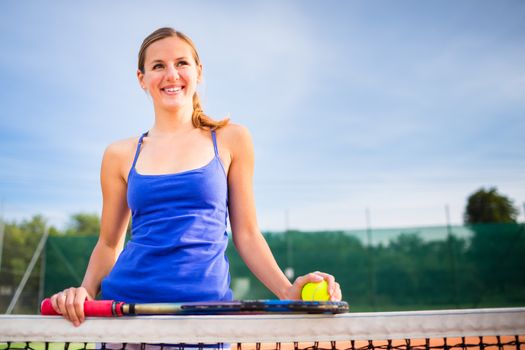 Portrait of a pretty young tennis player with copyspace