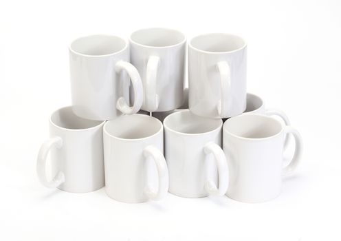 stack of white ceramic cups over white