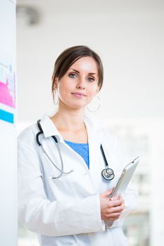 Pretty, female doctor in a hospital lab (image with copy space; color toned)