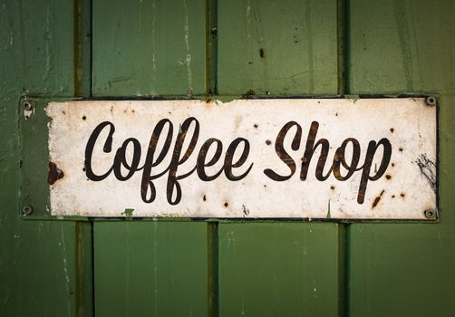 Rustic Retro Coffee Shop Sign On A Green Wooden Storefront