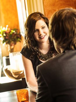 Photo of a young couple sitting in a restaurant on a romantic date.