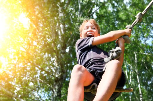 Kid Bungee jumping in the Summer Forest