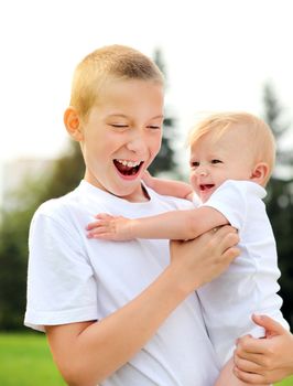 Happy Kid and Little Baby outdoor