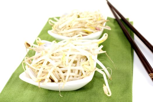 mung bean sprouts with chopsticks on a light background