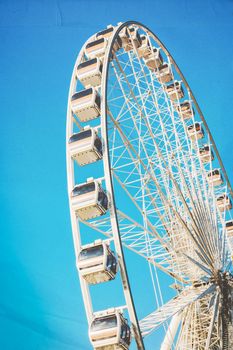 ferris wheel on blue sky, vintage texture