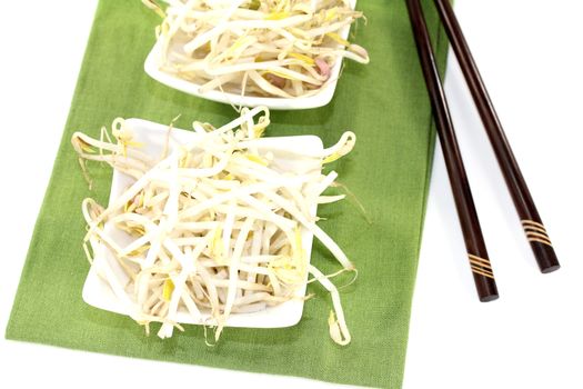 bright mung bean sprouts with chopsticks on a light background