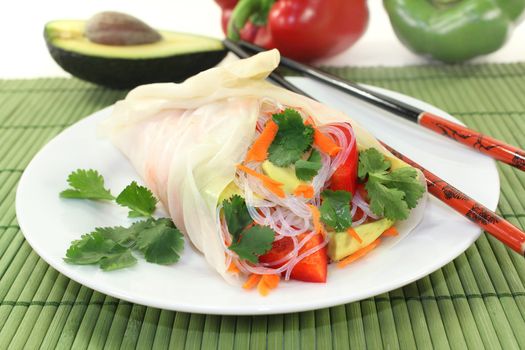 Rice paper stuffed with glass noodles, carrots, peppers and cilantro