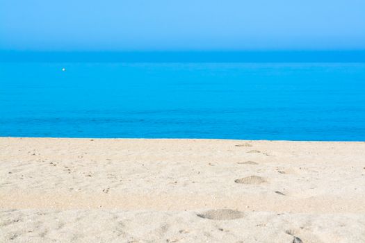 Sand tracks and footprints into the water. Mallorca, Balearic islands, Spain.