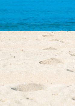 Sand tracks and footprints into the water. Mallorca, Balearic islands, Spain.