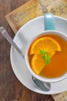 Tea and orange slices on old wood table