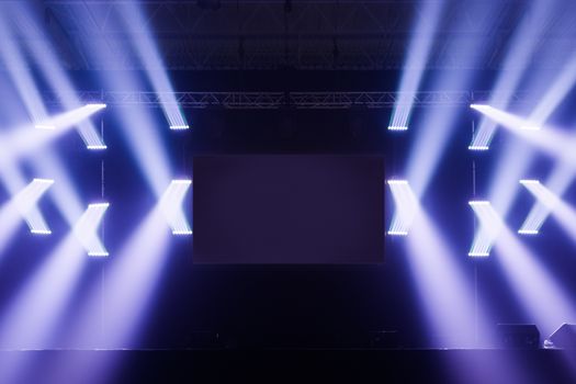 Spot lights on a Empty Stage With Blank Screen in the Middle before a Big Concert