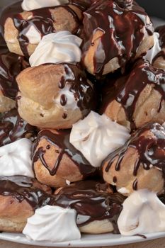 Cream puffs filled with cream covered with chocolate