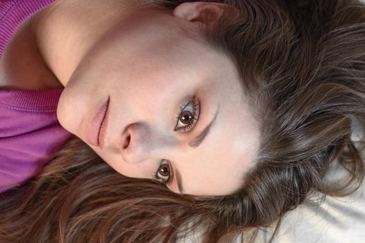 girl shot from above with loose hair and proud look