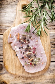 Pork chop, meat slices  on a wood background.