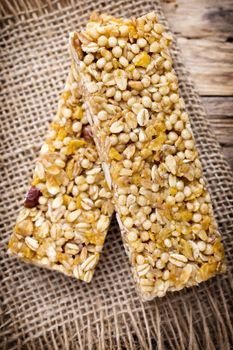 Muesli bars, cereal bars on the wooden background.