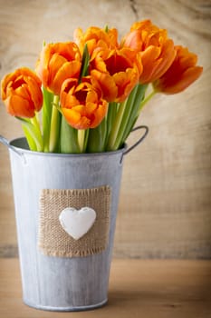 Tulips on a wooden surface. Studio photography.