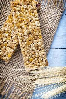 Muesli bars, cereal bars on the wooden background.