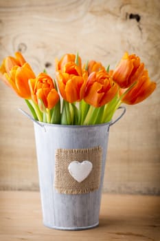 Tulips on a wooden surface. Studio photography.
